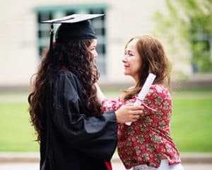 graduate and parent celebrating milestone