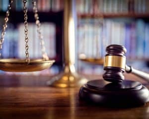 gavel with scale and books in the background