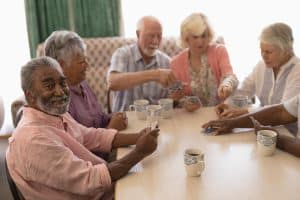 Group of senior people playing cards.