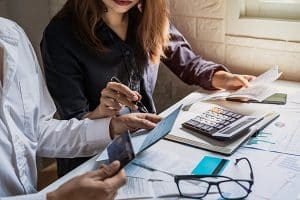 Two people managing finances and discussing risk of adding your child's name to a bank account