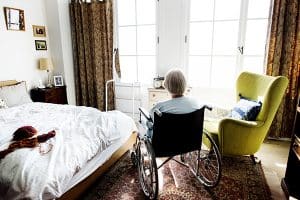 senior loneliness shown with Senior woman sitting on the wheelchair alone