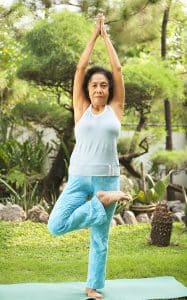 Combatting senior loneliness doing yoga at park in the morning.