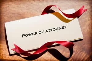 Power of Attorney Typed on a Folder Letter with a red ribbon around it