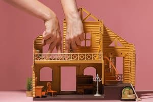 Community property shown by Toy House And Two Hands Represent Two Persons