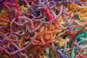 Colorful collection of tangled yarn showing tangled title abstract.