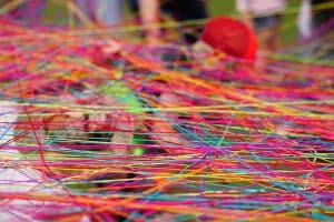 Close-up Of Multicolored Tangled Wool Threads And Yarn Balls.