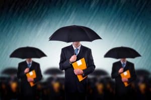 Somber image of men in black suits with black umbrellas while it's raining, carrying a manila enevelope