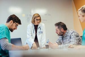 image of medical staff and MPOA have a conversation at a table