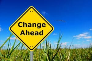 yellow road sign that reads "Change Ahead"
