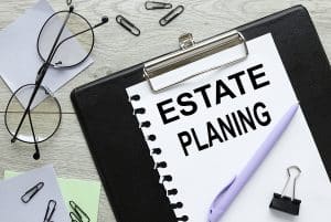 Estate Planning text on white paper on black folder