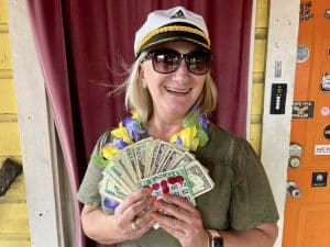 Not the lottery, but Jana won at Bingo this summer. Jana with cash fanned out with winning bingo card and captain hat.