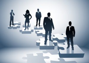silhouettes of trustees standing on floating puzzle pieces