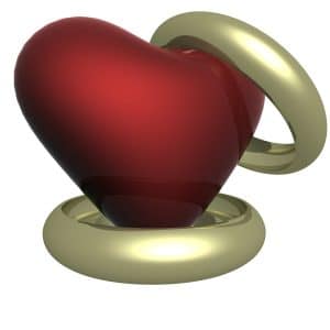 3D image of a red heart with 2 gold wedding rings