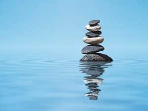 Stacked stones in water to illustrate simplicity to show minimalist estate planning.