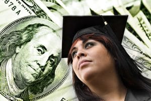 Close up of graduate with a hundred dollar bill