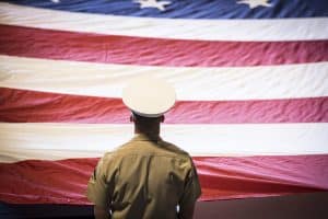 US Marine facing a US flag