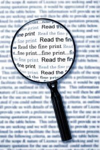 Magnifying glass over document highlighting the words "read the fine print"