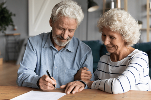 couple sitting together at a table working on their estate plan