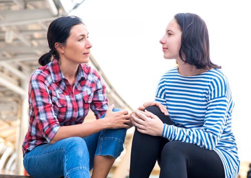 Mother with daughter having a conversation.