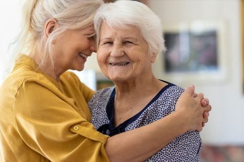 Woman spending time with her aging parent, her elderly mother