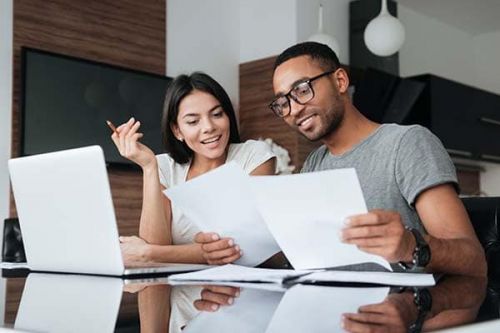 young couple filling out employment forms and choosing beneficiaries