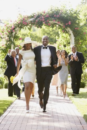 Newlyweds walk down the aisle after being married, family applauds