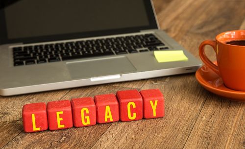 Legacy written on a wooden cube in front of a laptop to show avoiding a will contest
