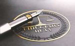 3D illustration of a fountain pen and a golden stamp with the text fiduciary duty.