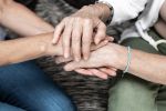 Aging Strategy. Senior mother and adult daughter giving support to each other. Closeup of senior and young woman holding hands. Mother and daughter Family affection concept