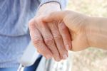 Older person, hand being held