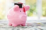 Piggy bank with a graduation mortar board cap concept for the 529 plan and tuition