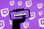 hand holding a phone showing a Twitch account
