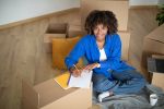 Happy Woman Making Checklist After Moving Away from home