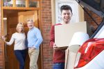 Son loading up car to move away to college and parents are waving to him from the door demonstrating need for HIPAA